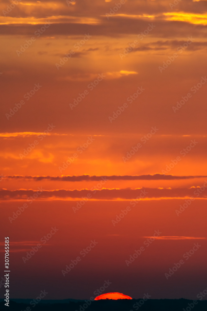 Obraz premium Fantastic clouds at sunrise, vertical panorama