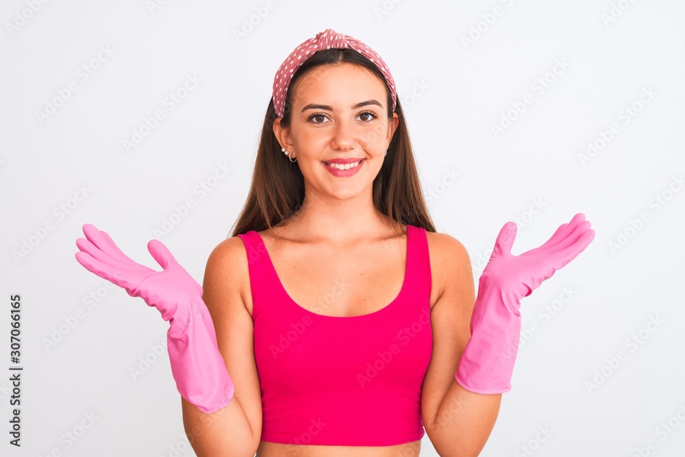Young beautiful girl wearing cleaner gloves standing over isolated white background with a happy face standing and smiling with a confident smile showing teeth Young beautiful girl wearing cleaner gloves standing over isolated white background with a happy face standing and smiling with a confident smile showing teeth