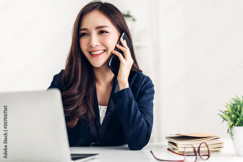 Businesswoman sitting and working with laptop computer.creative business people planning in her workstation at modern work loft Businesswoman sitting and working with laptop computer.creative business people planning in her workstation at modern work loft