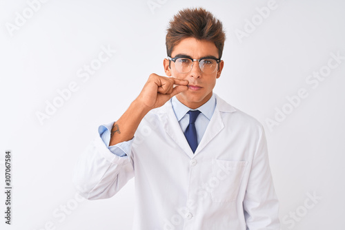 Young handsome sciencist man wearing glasses and coat over isolated white background mouth and lips shut as zip with fingers. Secret and silent, taboo talking