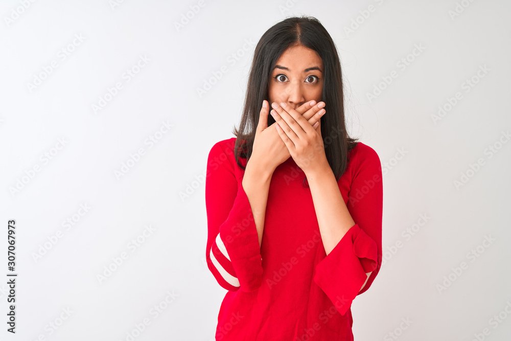 Young beautiful chinese woman wearing red dress standing over isolated white background shocked covering mouth with hands for mistake. Secret concept. Young beautiful chinese woman wearing red dress standing over isolated white background shocked covering mouth with hands for mistake. Secret concept.