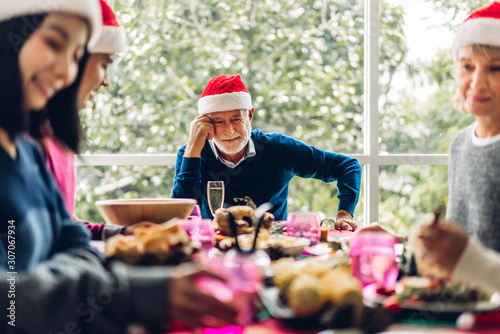 Portrait of happy big family celebrating in santa hats having fun and lunch together enjoying spending time together in christmas time at home