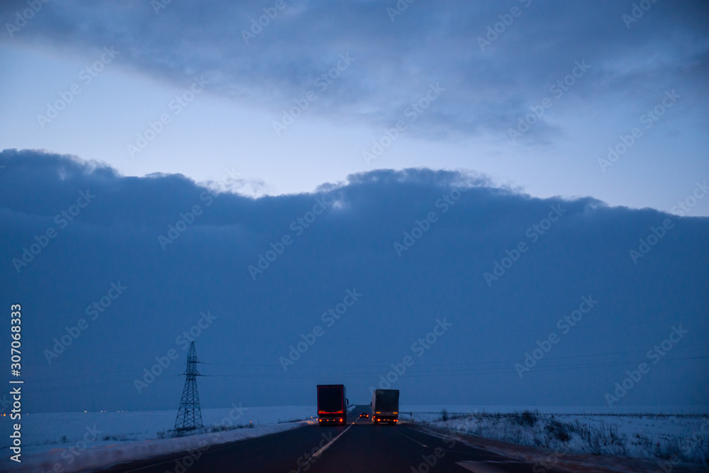 view of early morning at winter snowed highway