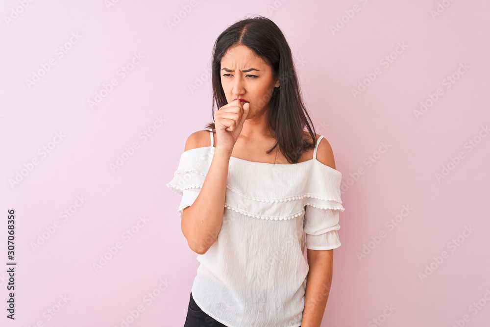 Beautiful chinese woman wearing white t-shirt standing over isolated pink background feeling unwell and coughing as symptom for cold or bronchitis. Healthcare concept. Beautiful chinese woman wearing white t-shirt standing over isolated pink background feeling unwell and coughing as symptom for cold or bronchitis. Healthcare concept.