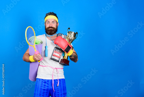 excited mature champion. Sport shop assortment. Get body ready for summer. Man bearded athlete hold sport equipment. Choose sport you like. copy space. motivation concept. happiness lifestyle