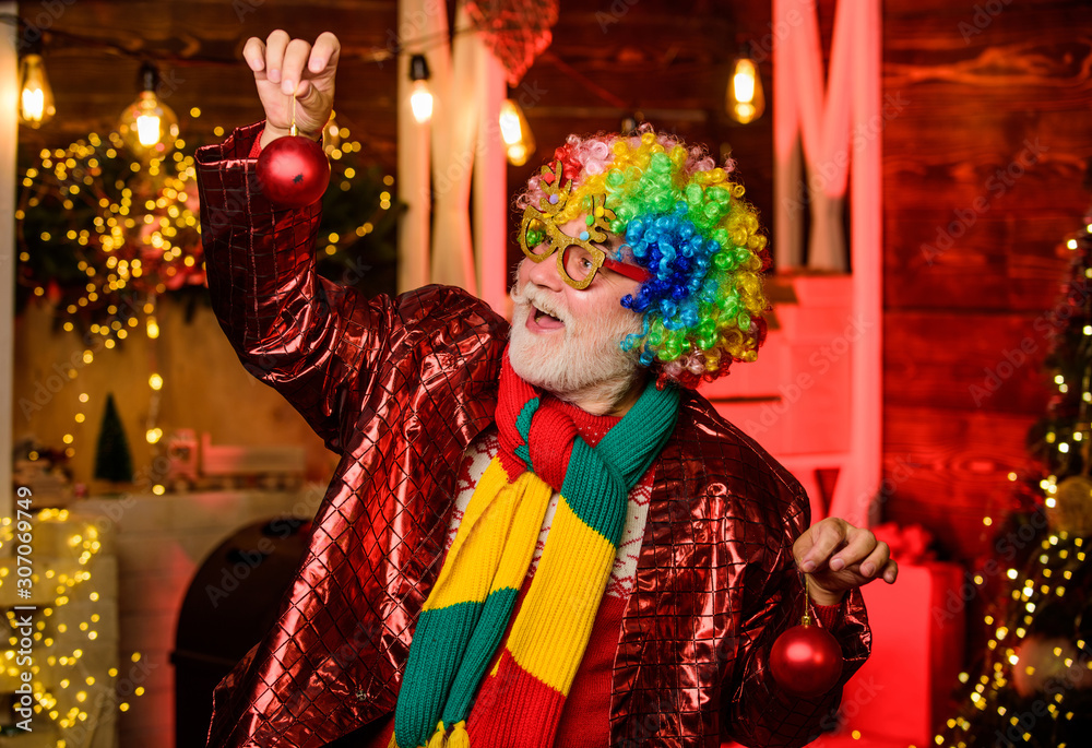 Party entertainment. Cheerful clown colorful hairstyle. Mature man with white beard. Winter holidays. Christmas decorations home. Christmas spirit. Bearded grandfather senior man celebrate christmas