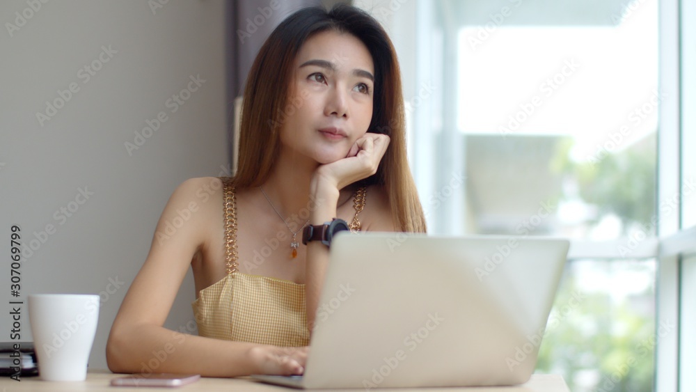 Young beautiful woman working with laptop at coffee shop Young beautiful woman working with laptop at coffee shop