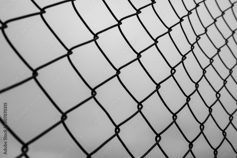 Abstract image of selective focus at iron fence with sky in black and white tone. Abstract image of selective focus at iron fence with sky in black and white tone.