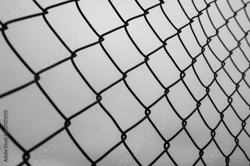 Abstract image of selective focus at iron fence with sky in black and white tone.