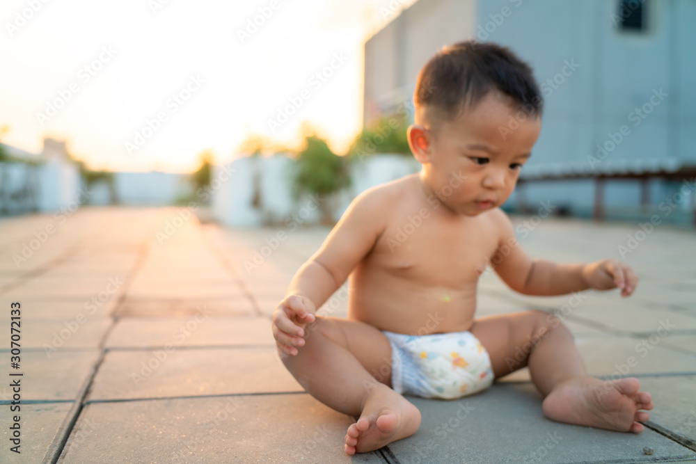Adorable baby boy playing outdoor sunset light Adorable baby boy playing outdoor sunset light