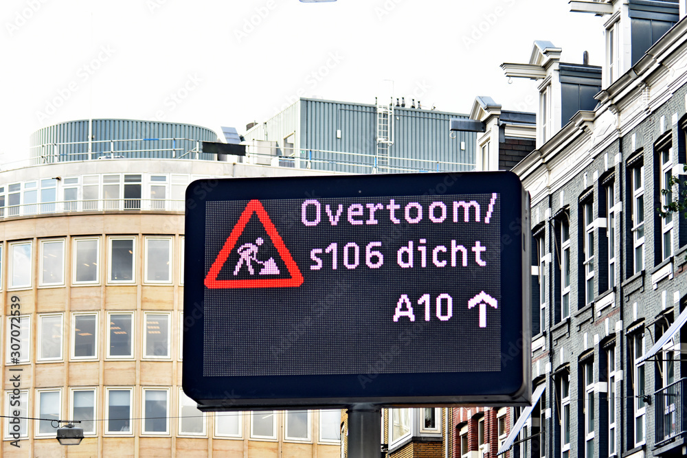 Fototapeta premium road sign warning of repair work on a street of a European city