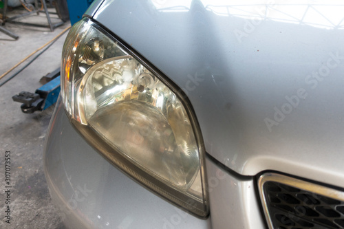 Dirty headlamp of car, background