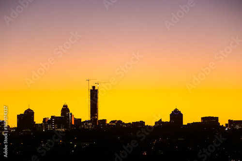 Sunset Silhouette Skyline looking over construction cranes and buildings in Sandton CBD Johannesburg