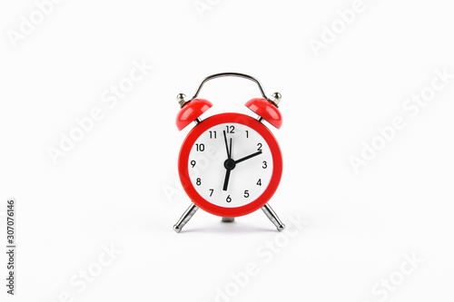 Red retro alarm clock on a white background. Round red alarm clock on a white background isolated. standard timer concept, warning of a change in time, retro signal of the beginning of the work of the