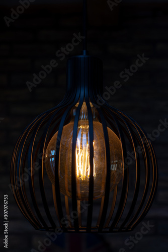 Edison bulb in a stylish lamp. Eddison bulb. Detail of interior lamp. 