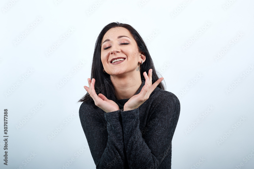 Charming caucasian young woman in fashion black sweater holding hands over head, smiling, looking pretty isolated white background, Lifestyle concept Charming caucasian young woman in fashion black sweater holding hands over head, smiling, looking pretty isolated white background, Lifestyle concept
