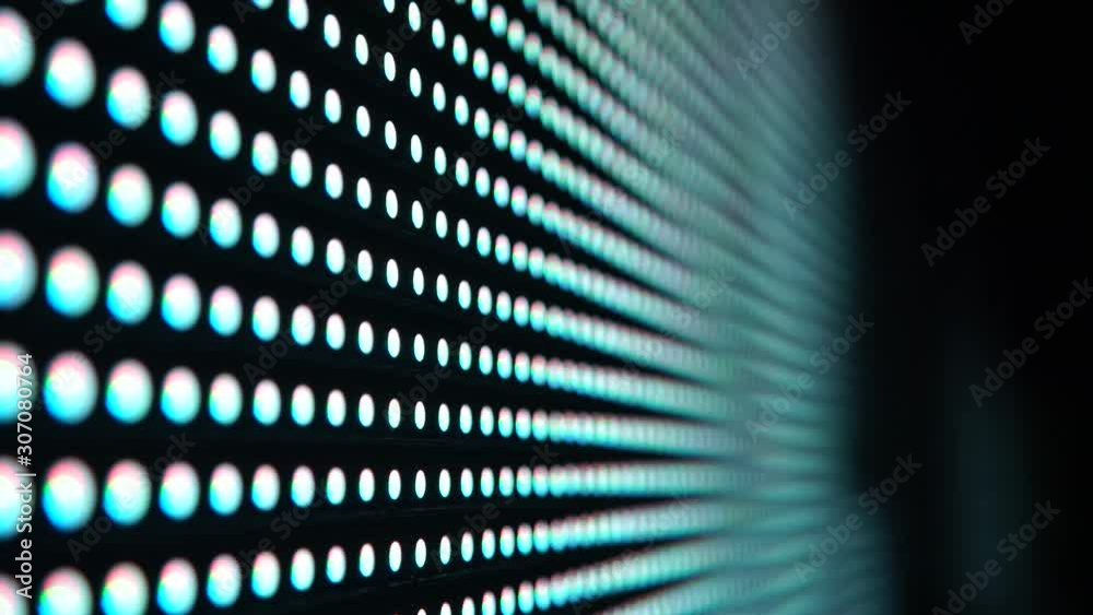 Multicolored glowing RGB dots diode blinking disco lights. RGB multicolored dots led light panel at the night club, led light wall VJ background.