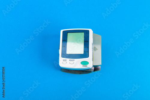 Tonometer for pressure. electronic portable blood pressure monitor. View from above. on a blue background.