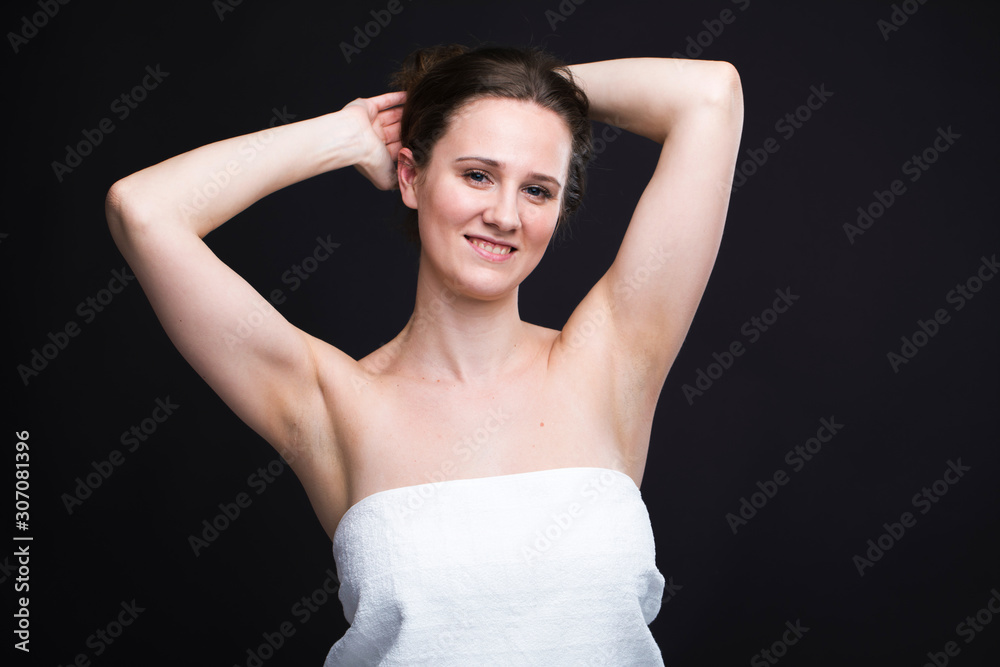 Brunette woman in a white towel with your hands up Brunette woman in a white towel with your hands up