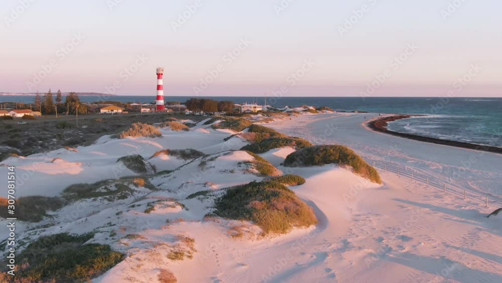 Aerial: Gorgeous sunset footage of Geraldton beach on west end and lighthouse in the background. Western Australia.