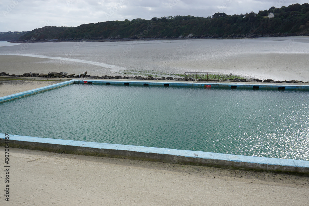 view of a beachfront pool and low tide in the harbor in Brittany, France