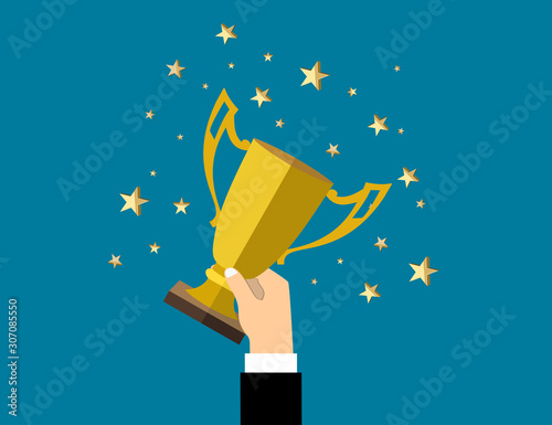Businessman holding up a winning trophy. Business concept