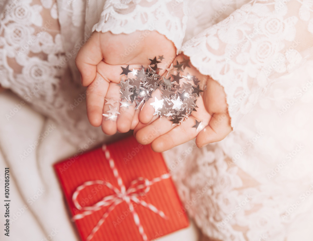 Silver stars sparkling on child's hands and palms. Silver stars sparkling on child's hands and palms.