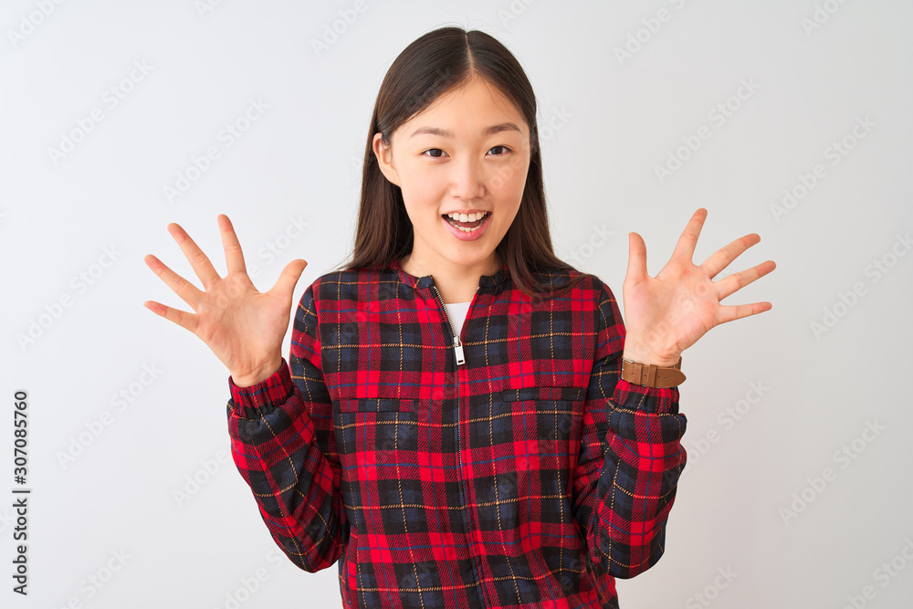 Young chinese woman wearing casual jacket standing over isolated white background celebrating crazy and amazed for success with arms raised and open eyes screaming excited. Winner concept Young chinese woman wearing casual jacket standing over isolated white background celebrating crazy and amazed for success with arms raised and open eyes screaming excited. Winner concept