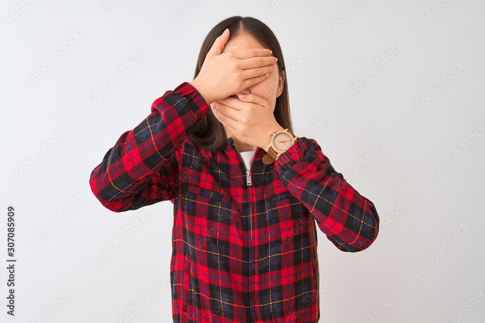 Young chinese woman wearing casual jacket standing over isolated white background Covering eyes and mouth with hands, surprised and shocked. Hiding emotion Young chinese woman wearing casual jacket standing over isolated white background Covering eyes and mouth with hands, surprised and shocked. Hiding emotion