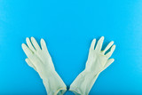 White gloves on a blue background. White latex gloves with a blue background. View from above
