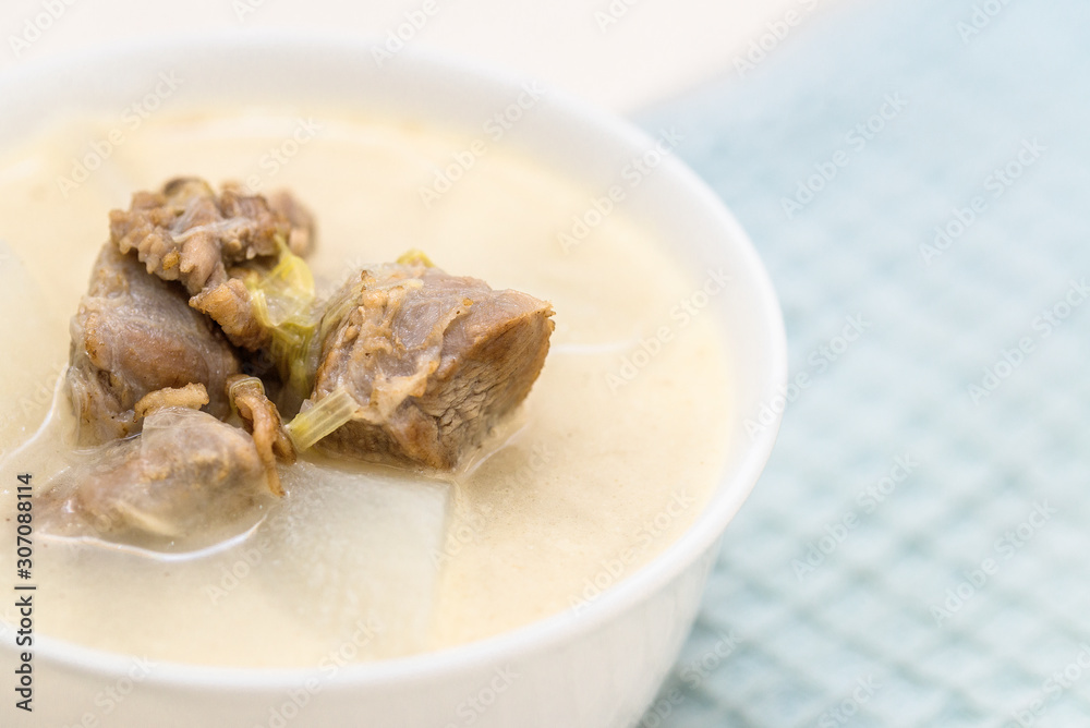 A bowl of mutton stew with radishes was set on the table A bowl of mutton stew with radishes was set on the table