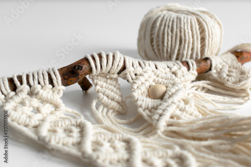 Obraz na plátně Handmade macrame braiding and cotton threads on rustic wooden stick