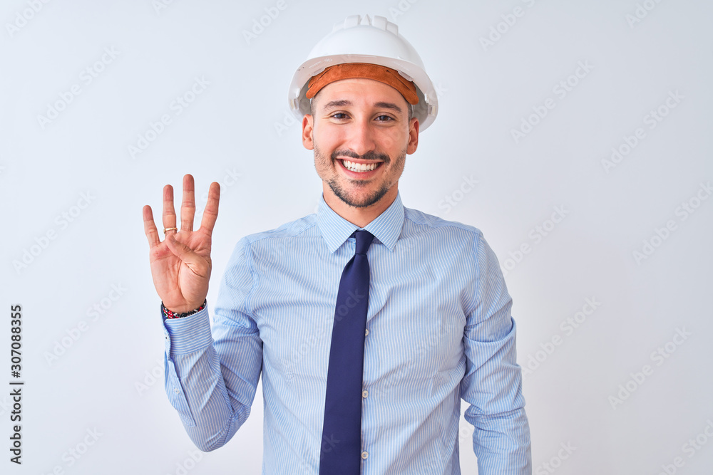 Young business man wearing contractor safety helmet over isolated background showing and pointing up with fingers number four while smiling confident and happy. Young business man wearing contractor safety helmet over isolated background showing and pointing up with fingers number four while smiling confident and happy.