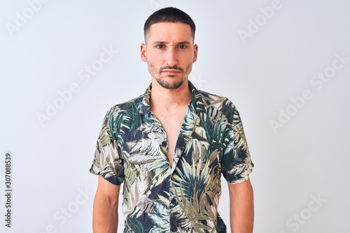 Wallpaper Mural Young handsome man wearing Hawaiian summer shirt over isolated background skeptic and nervous, frowning upset because of problem. Negative person. Torontodigital.ca