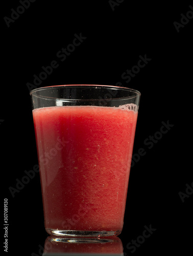 Healthy watermelon smoothie isolated on black background