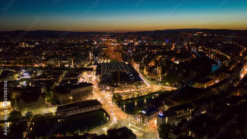 sunset night illuminated zurich city lakeside and traffic train station square aerial panorama 4k timelapse switzerland 