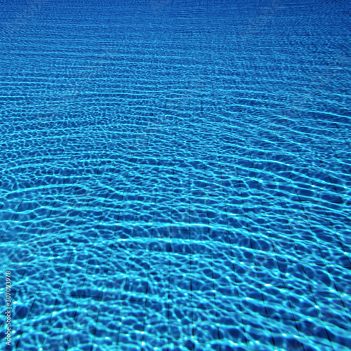 Solar highlights from the surface of the water are reflected at the bottom of the pool.
