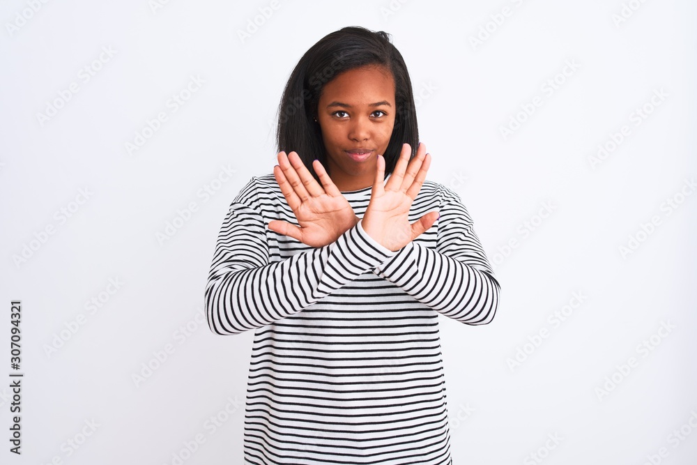 Beautiful young african american woman wearing winter sweater over isolated background Rejection expression crossing arms and palms doing negative sign, angry face Beautiful young african american woman wearing winter sweater over isolated background Rejection expression crossing arms and palms doing negative sign, angry face