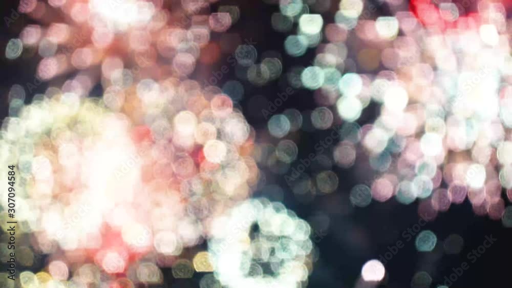 loop seamless of real fireworks background. abstract blur of real golden shining fireworks with bokeh lights in the night sky. glowing fireworks show. New year's eve fireworks celebration