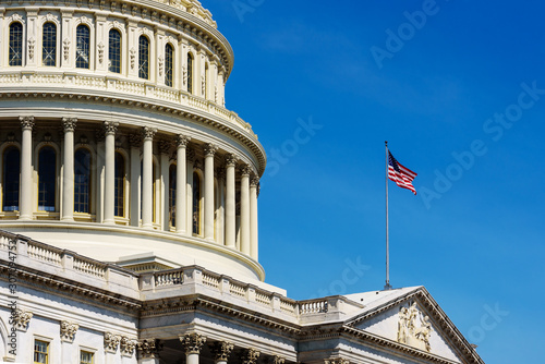 Close up of United States Capitol Building and American waving flag, Washington DC