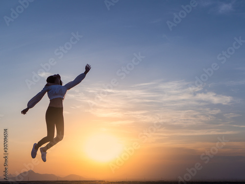 Wallpaper Mural Free young woman slim body at golden sunset. Freedom and success concept,relaxing and enjoying a sunny summer holiday. Torontodigital.ca