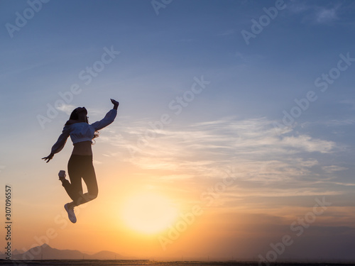 Wallpaper Mural Free young woman slim body at golden sunset. Freedom and success concept,relaxing and enjoying a sunny summer holiday. Torontodigital.ca