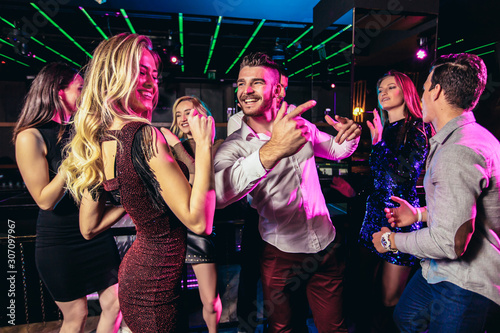 Young people dancing in night club