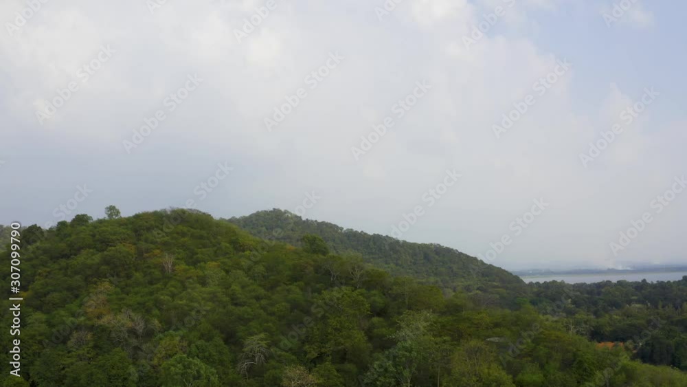 Aerial view Drone flying over a beautiful green mountain forest. Tourist destination on a hilltop during the foggy and beautiful light in the morning and sunset in Chiang Rai Thailand. Footage B roll. Aerial view Drone flying over a beautiful green mountain forest. Tourist destination on a hilltop during the foggy and beautiful light in the morning and sunset in Chiang Rai Thailand. Footage B roll.