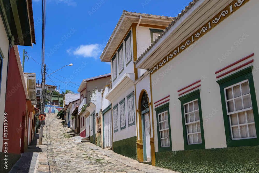 View to steep cobblestone street with traditional houses in historical town São Luíz do Paraitinga, Brazil