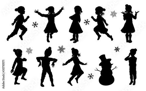 A set of children in silhouette playing having fun in Christmas or winter cold weather clothing
