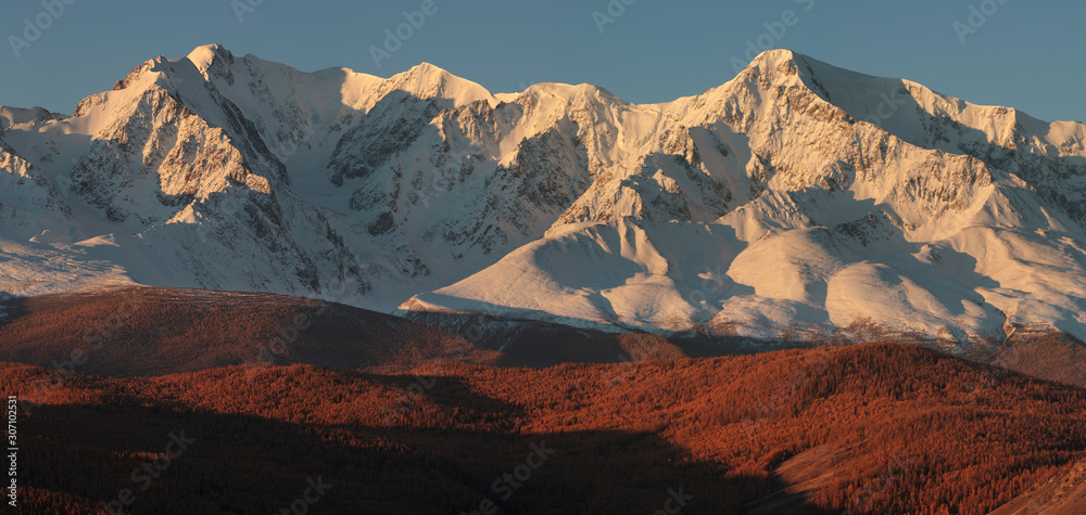 Snow-capped mountain peaks in the morning light. Traveling in the mountains, climbing.