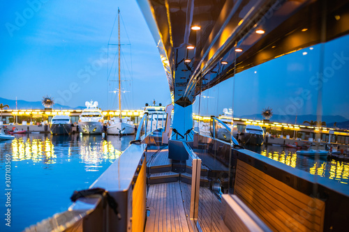 Beautiful illuminated Monacor port reflecting in the mirror walls of a luxury yacht photo
