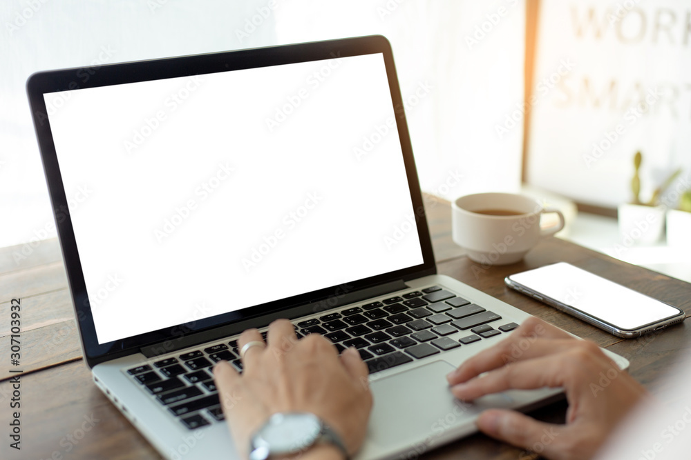 mockup image blank screen computer with blank white background for advertising text,hand man using laptop contact business search information on desk at home office.marketing and creative design mockup image blank screen computer with blank white background for advertising text,hand man using laptop contact business search information on desk at home office.marketing and creative design