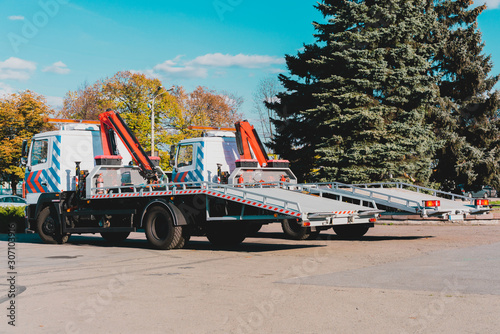Canvastavla Two new tow trucks parked near the road in the city
